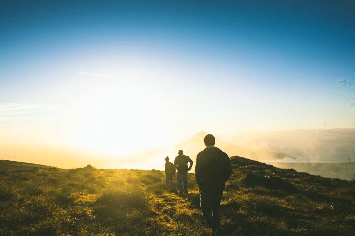 a man standing in front of a sunset